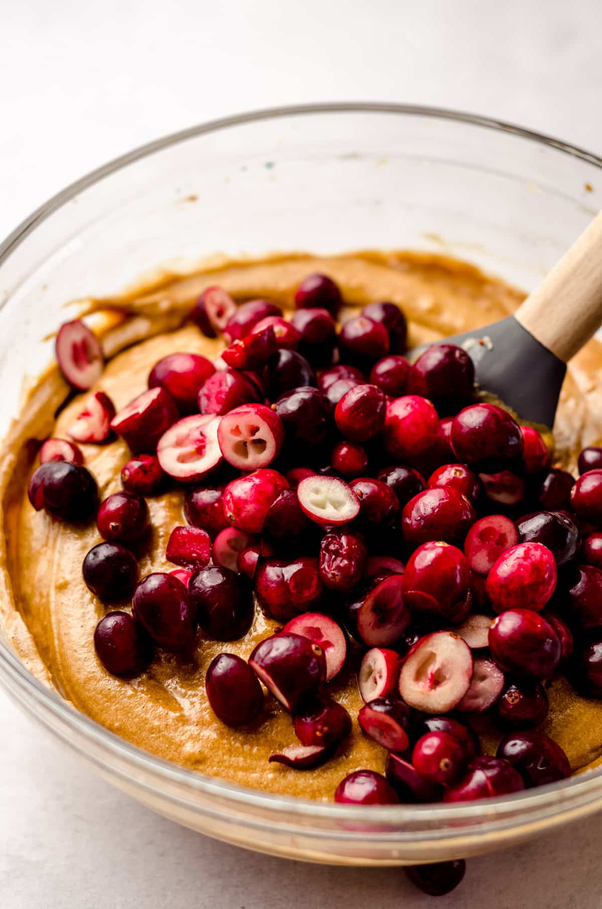 gingerbread loaf batter with chopped cranberries ready to be stirred into it