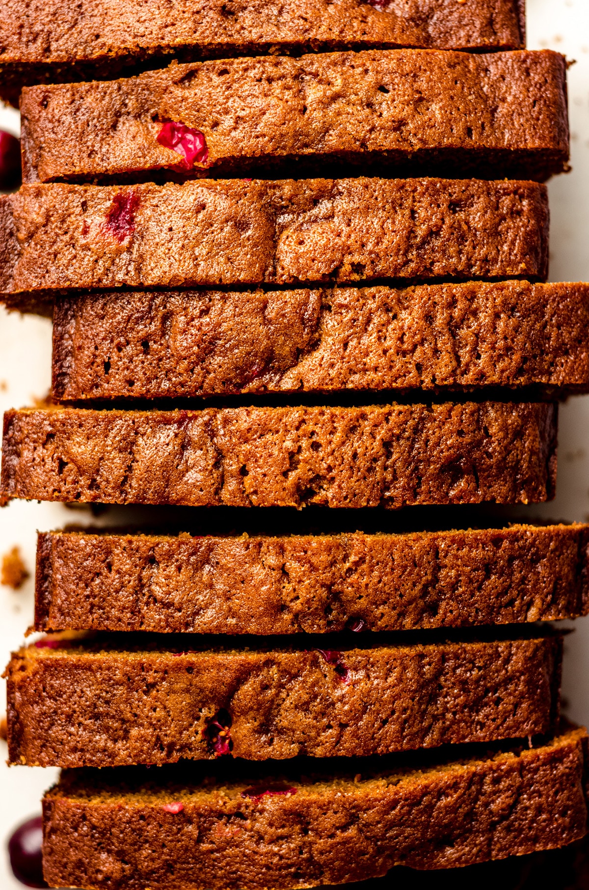 aerial photo of a loaf of cranberry gingerbread cut into slices