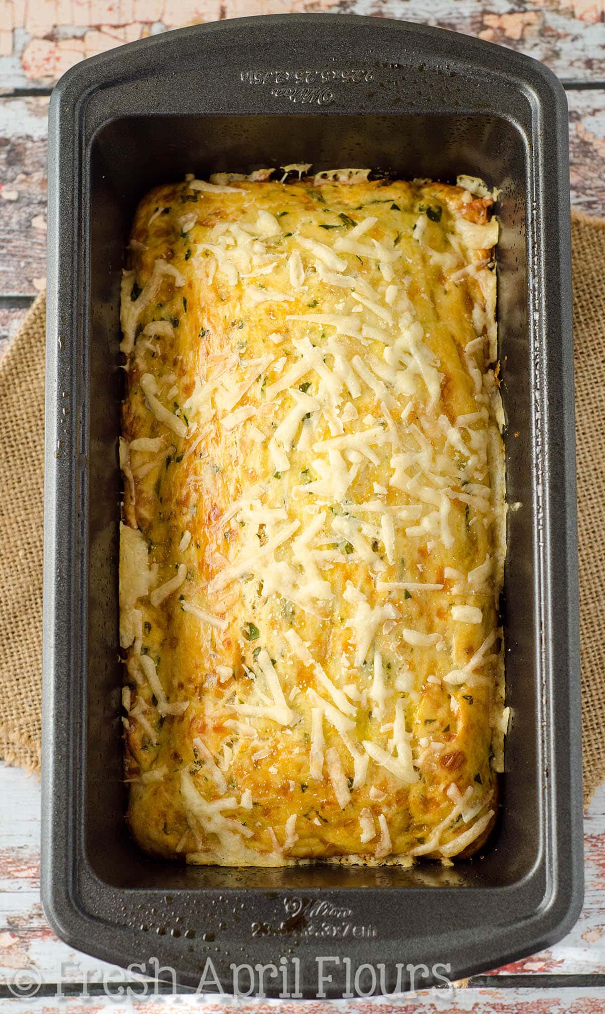 Parmesan parsley bread in a loaf pan.