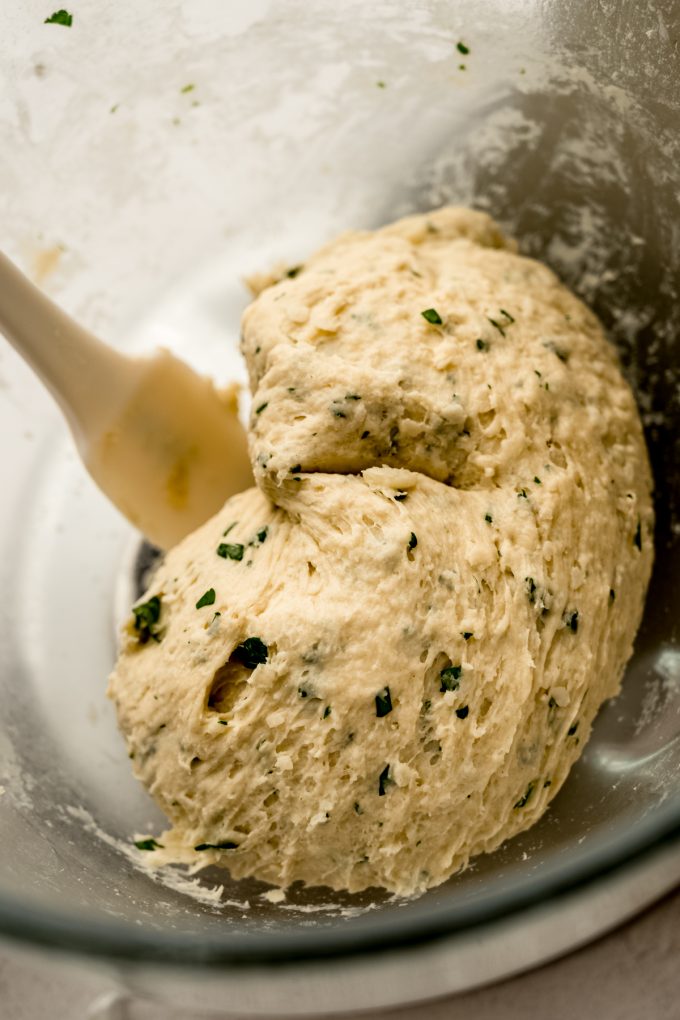 Parmesan parsley bread dough in a large bowl.