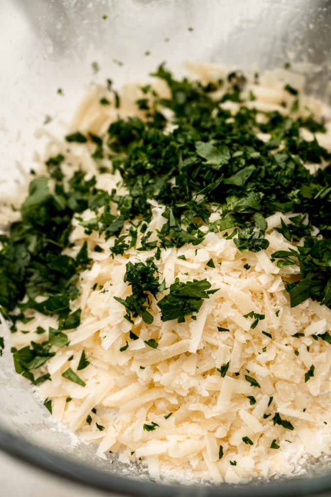 Parmesan parsley bread dough in a large bowl.