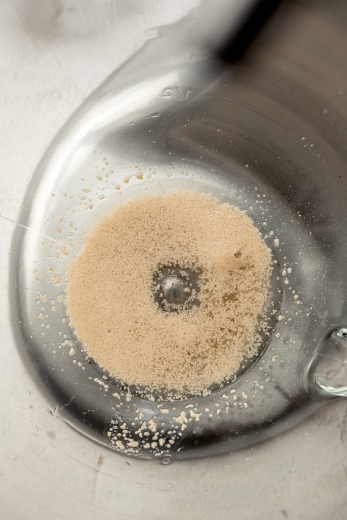 Proofed yeast in the bottom of the bowl of a stand mixer.