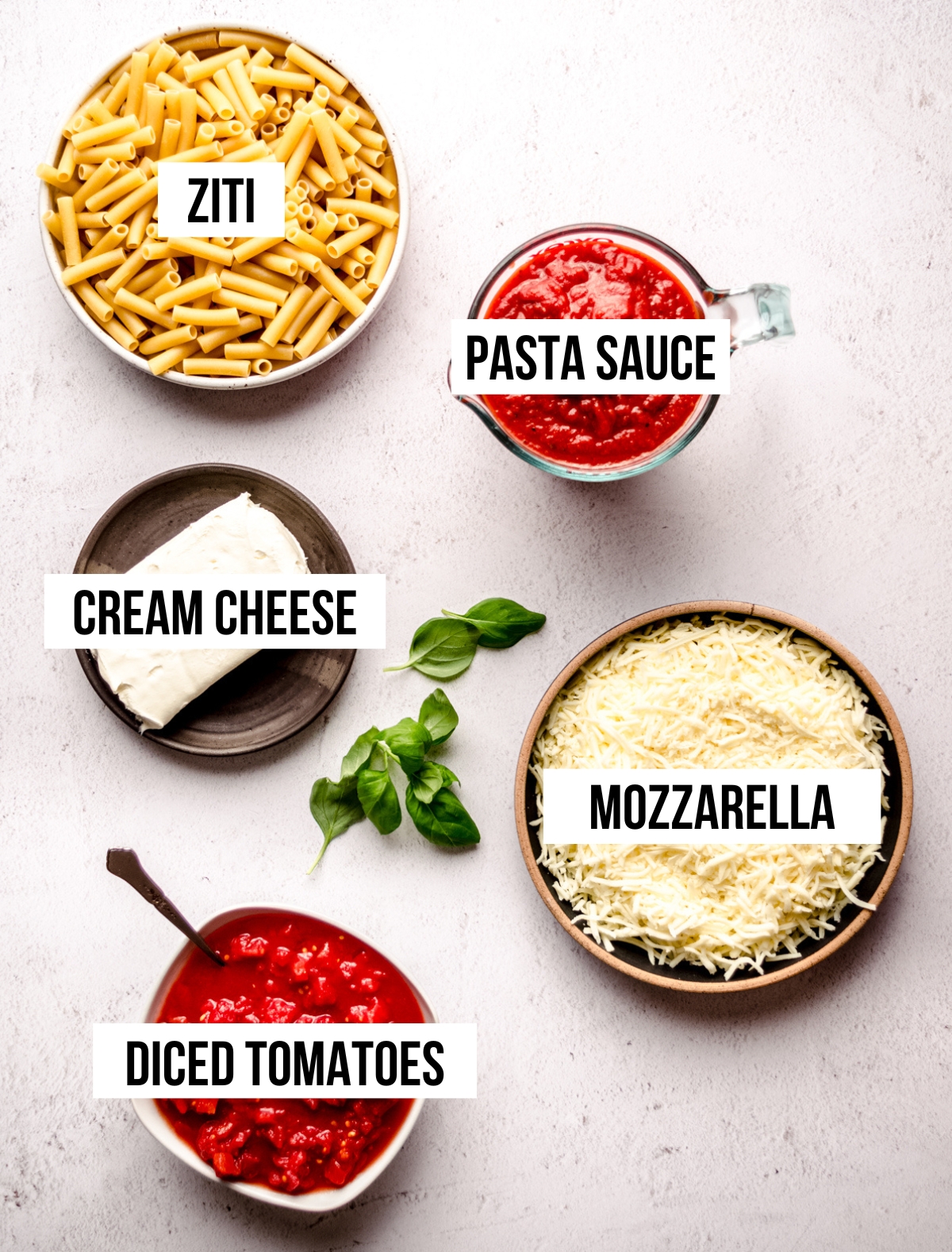Aerial photo of ingredients for baked ziti with text overlay.