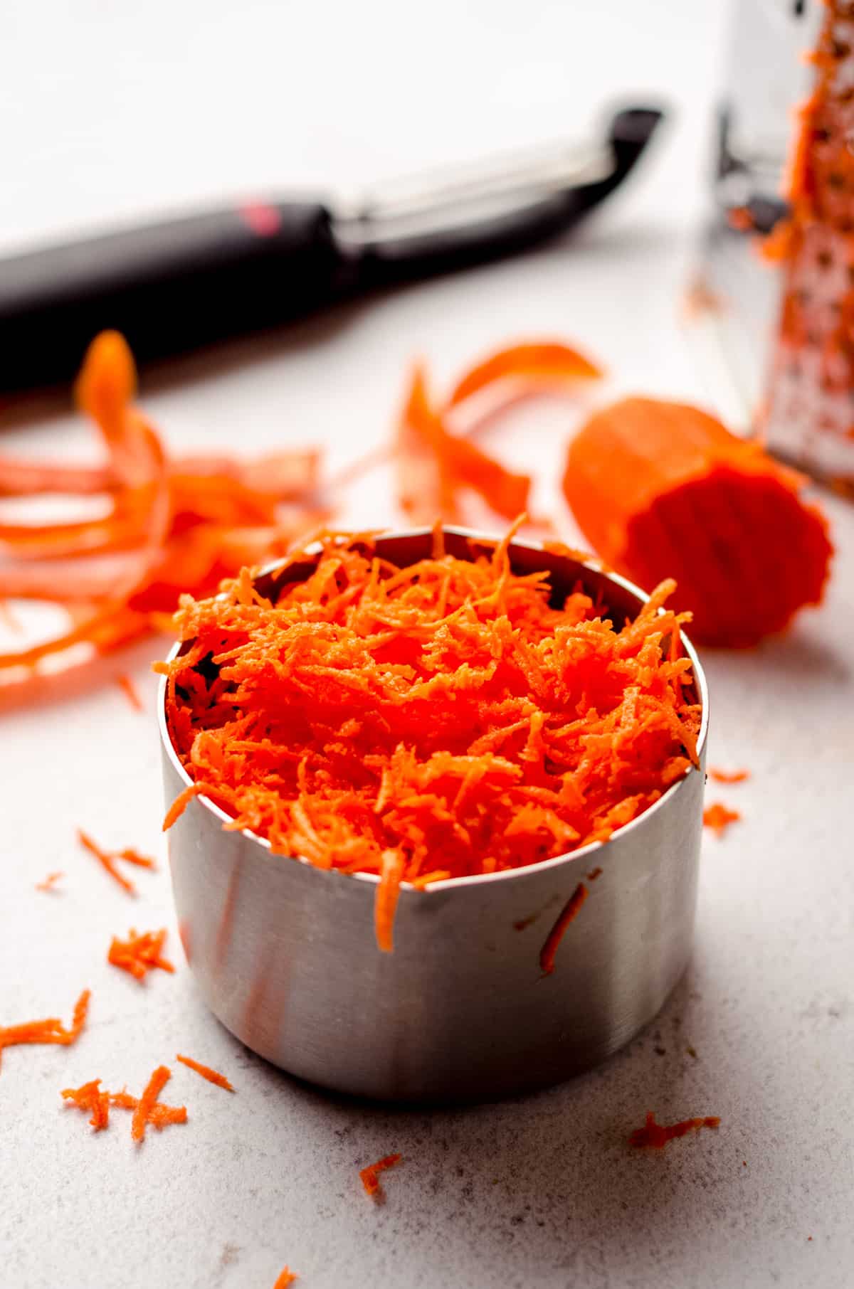 grated carrots in a measuring cup