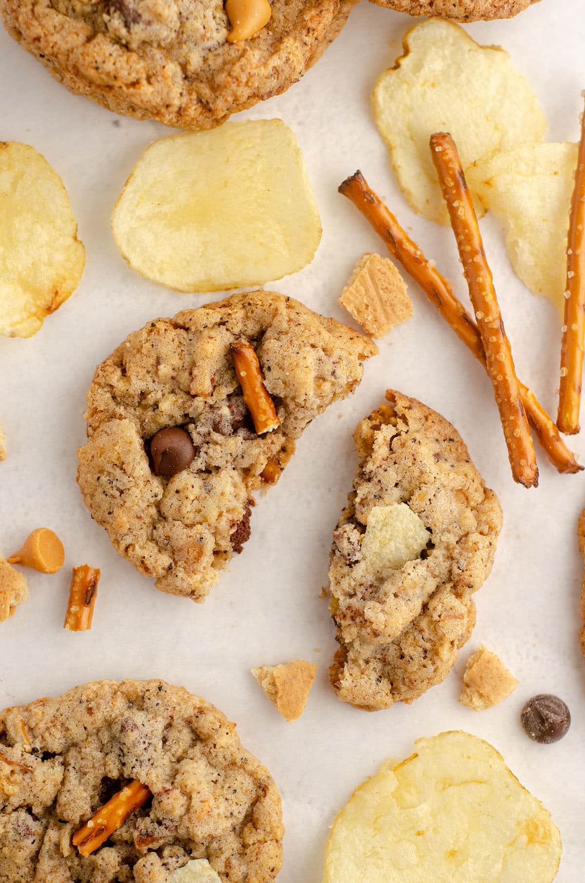 aerial photo of compost cookie scattered with pretzels, chips, butterscotch chips, chocolate chips, and graham cracker pieces