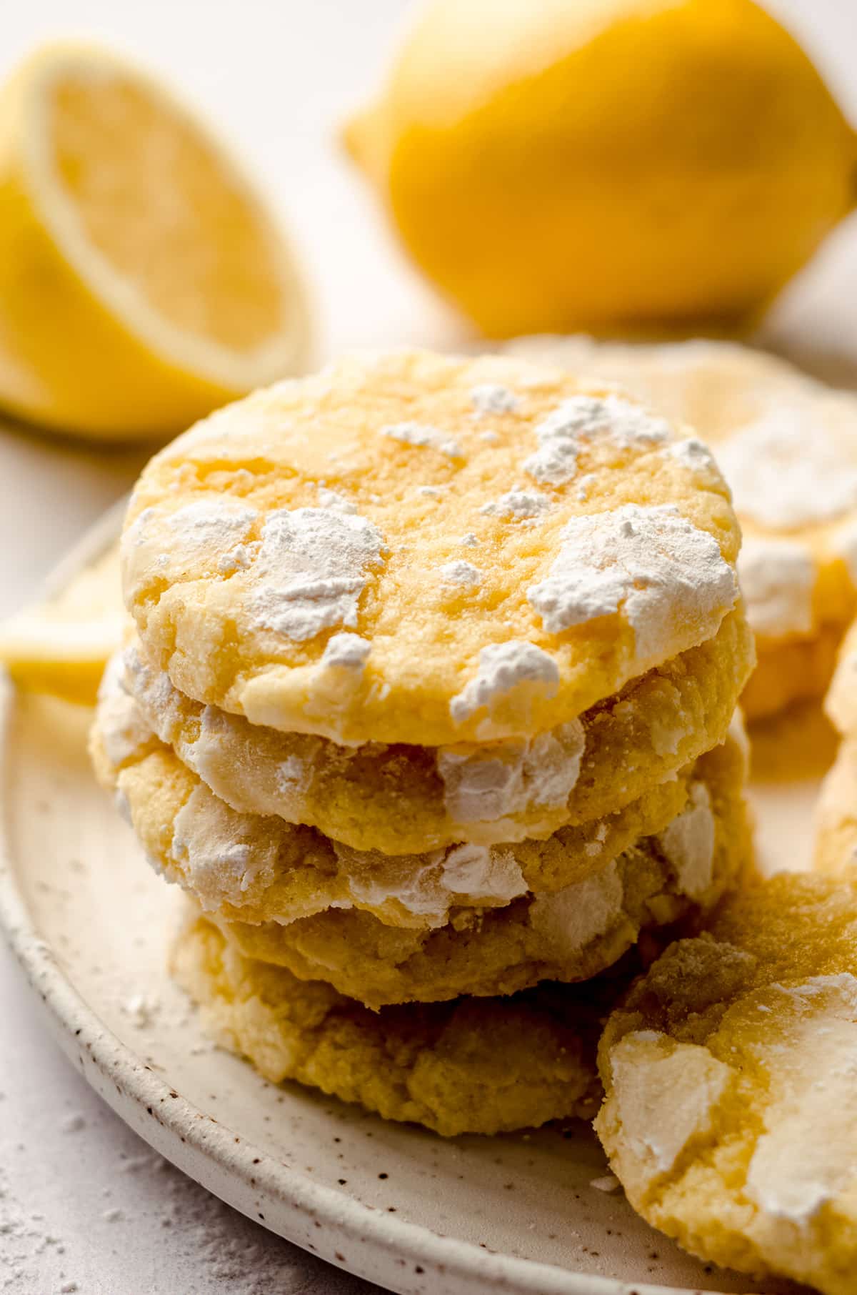 a stack of lemon crinkle cookies on a plate