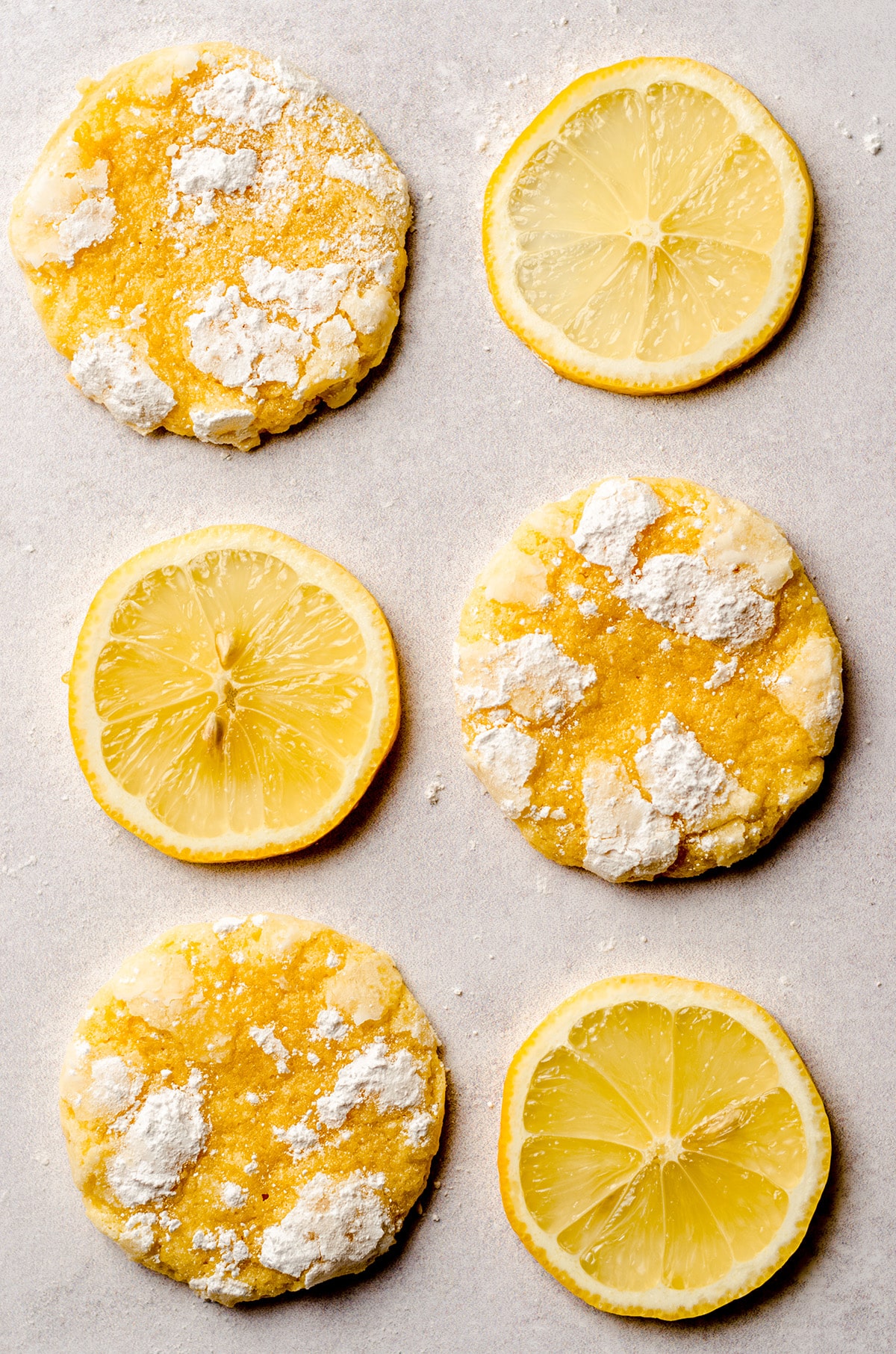 lemon crinkle cookies alternating with slices of lemon