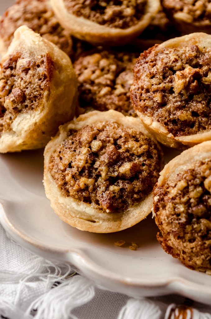 Pecan pie tarts on a plate.