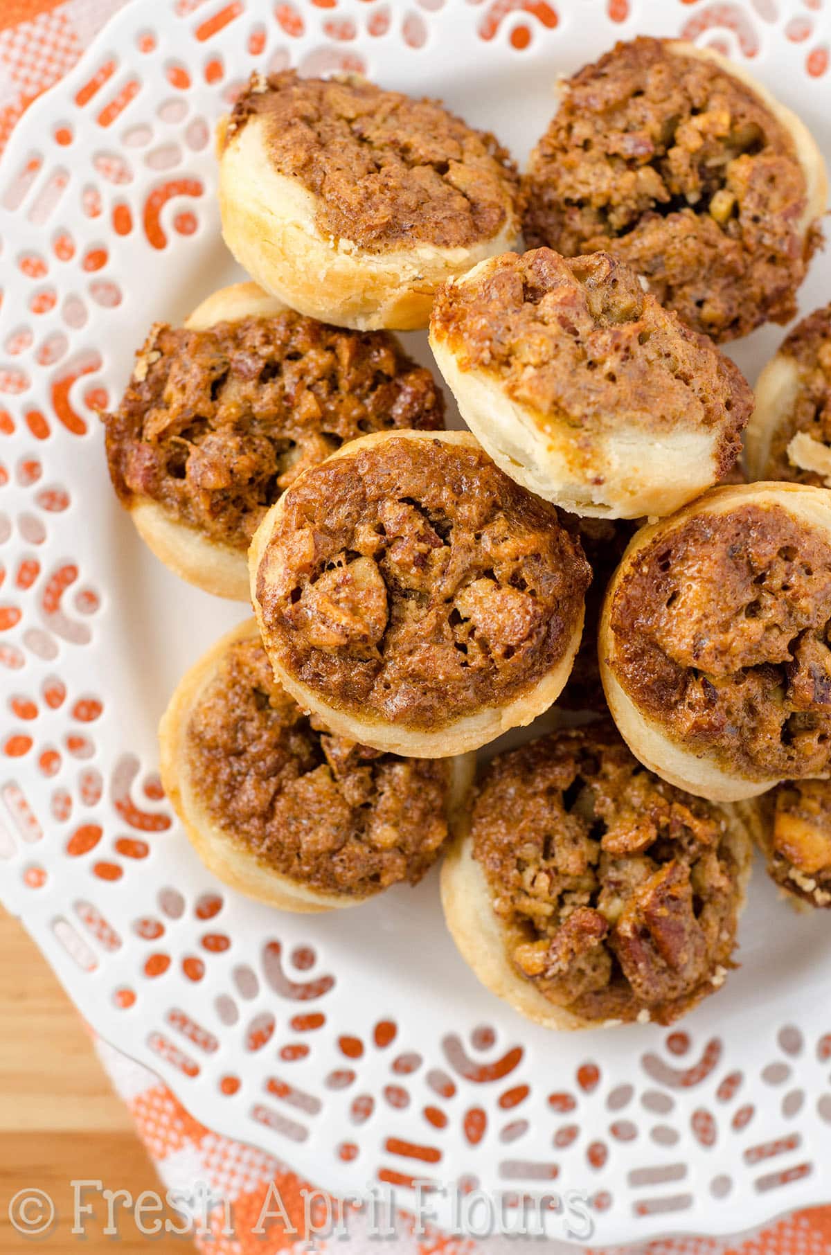 Pecan pie tarts on a plate.