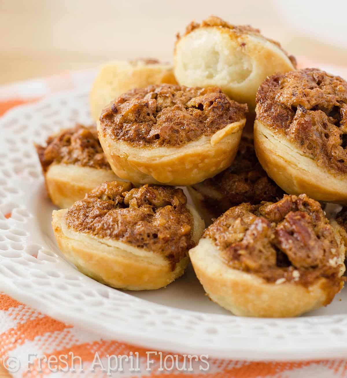 Pecan pie tarts on a plate.