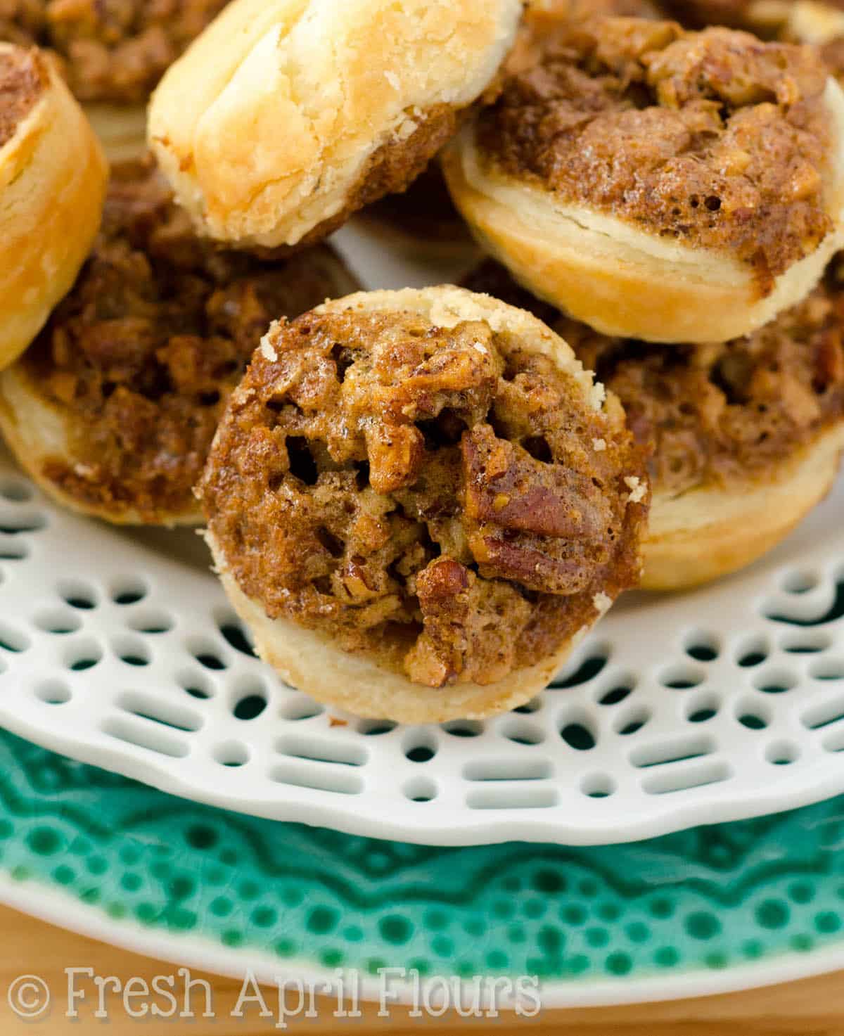 Pecan pie tarts on a plate.