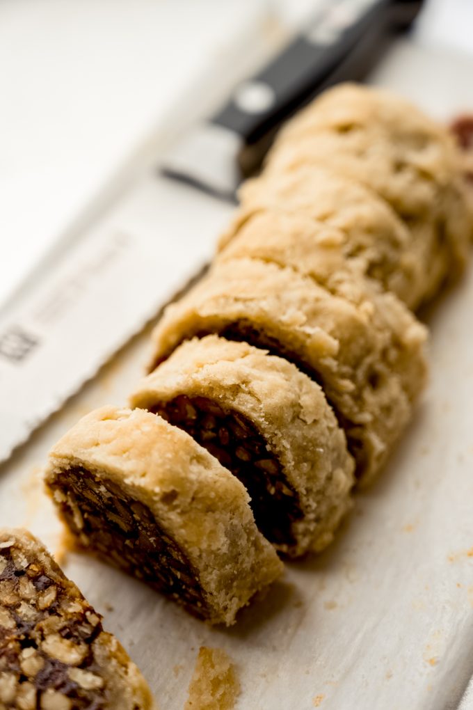 Honey walnut cookie stick slices (sfratti) on a surface.
