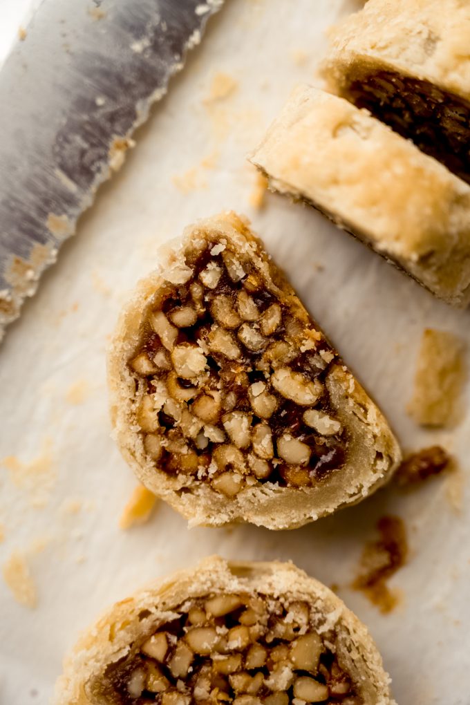 Aerial photo of honey walnut cookie stick slices (sfratti) on a surface.