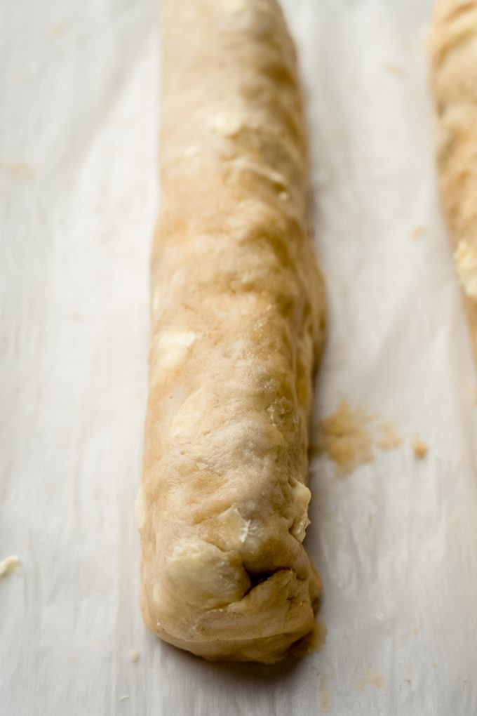 A honey walnut cookie stick on a baking sheet.