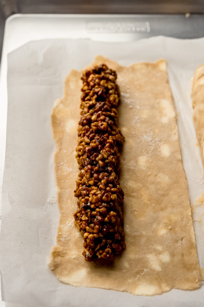 Honey walnut cookie stick filling on a pie dough.