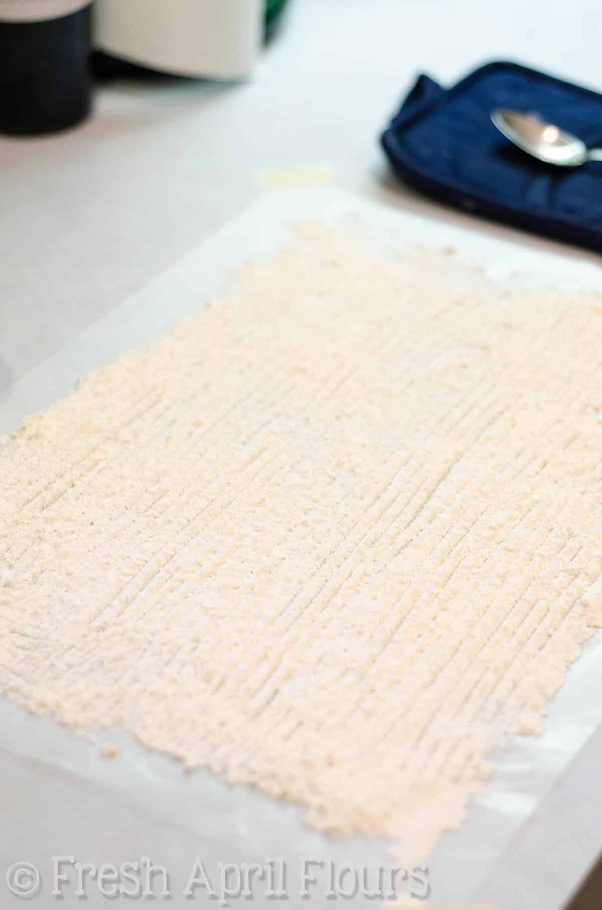 flour laid out on wax paper to form filling for honey walnut cookie sticks
