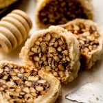 Honey walnut cookie stick slices (sfratti) on a surface.