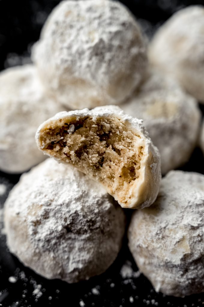 A snowball cookie with a bite taken out of it.