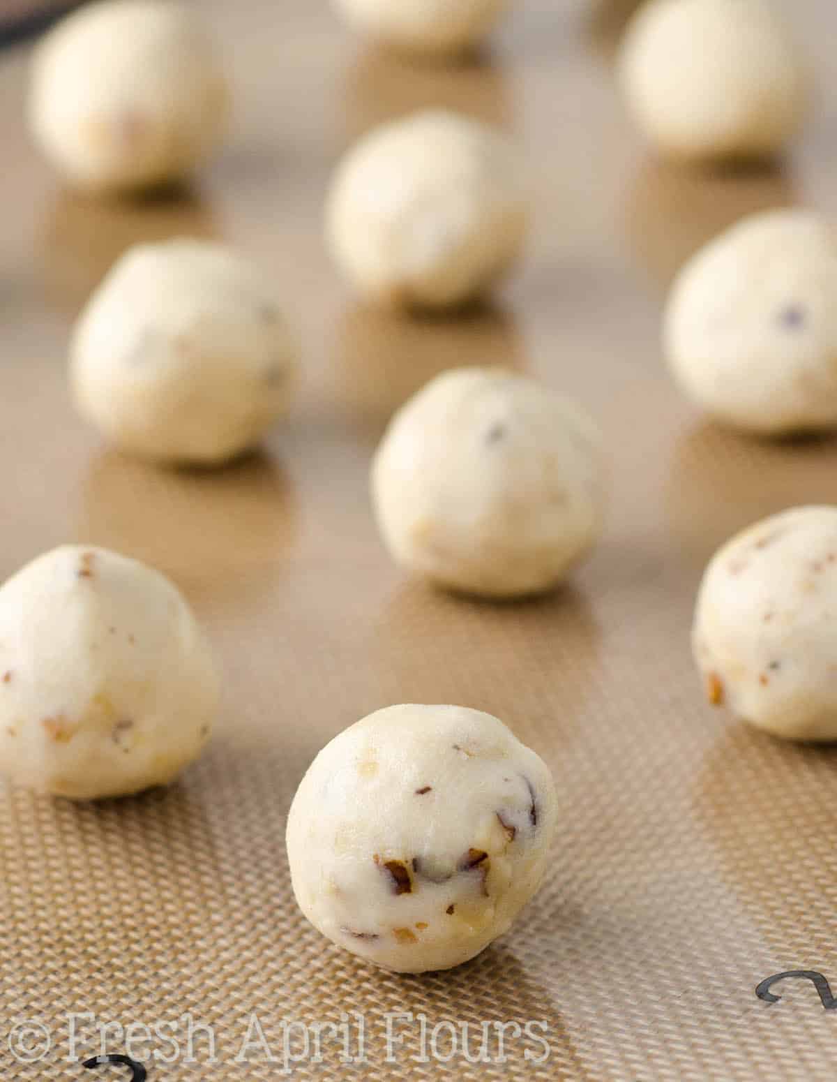 russian tea cake cookie dough balls on a baking sheet