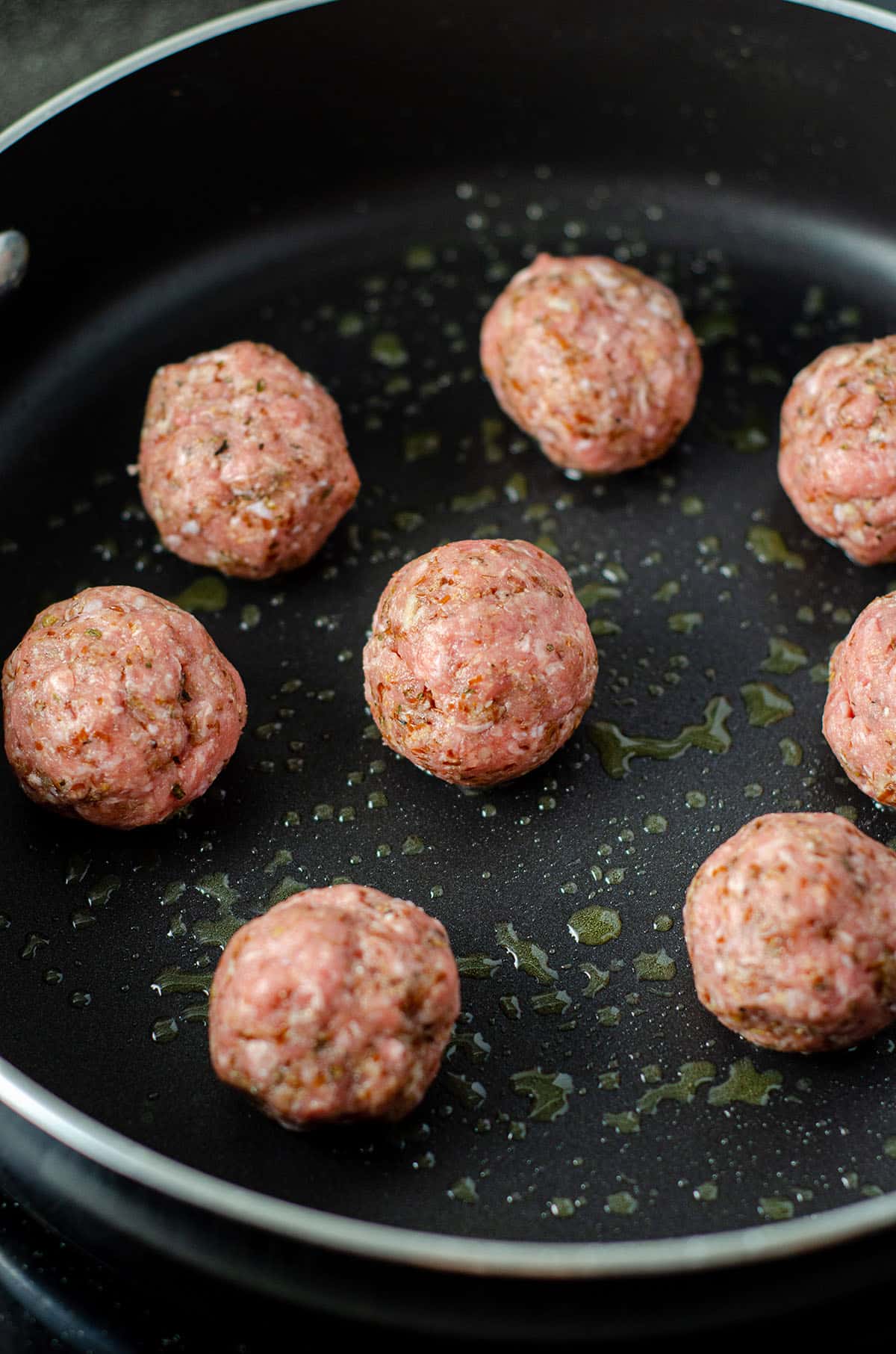 meatballs browning in a skillet