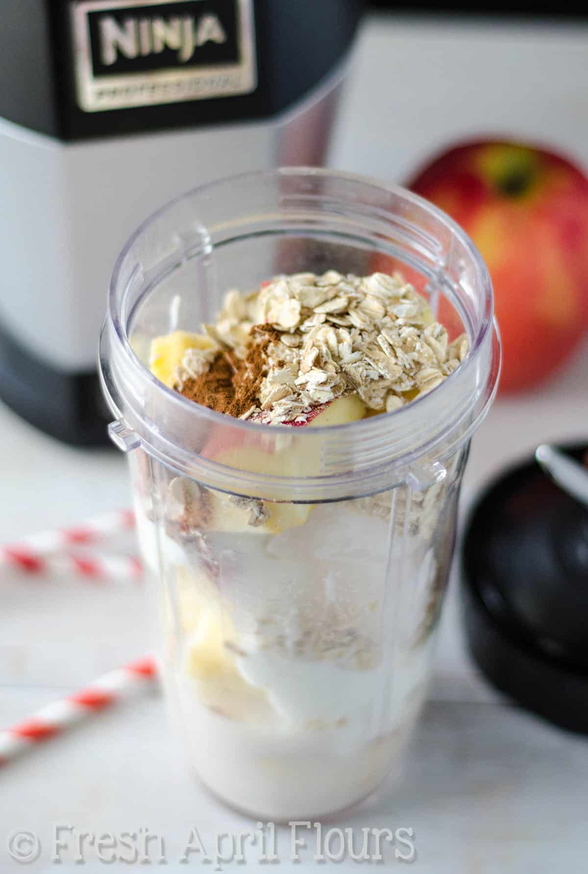 Apple pie smoothie ingredients in a mini blender. 