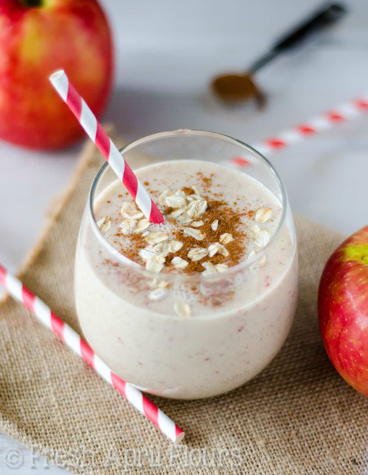 Aerial photo of an apple pie smoothie in a glass. 