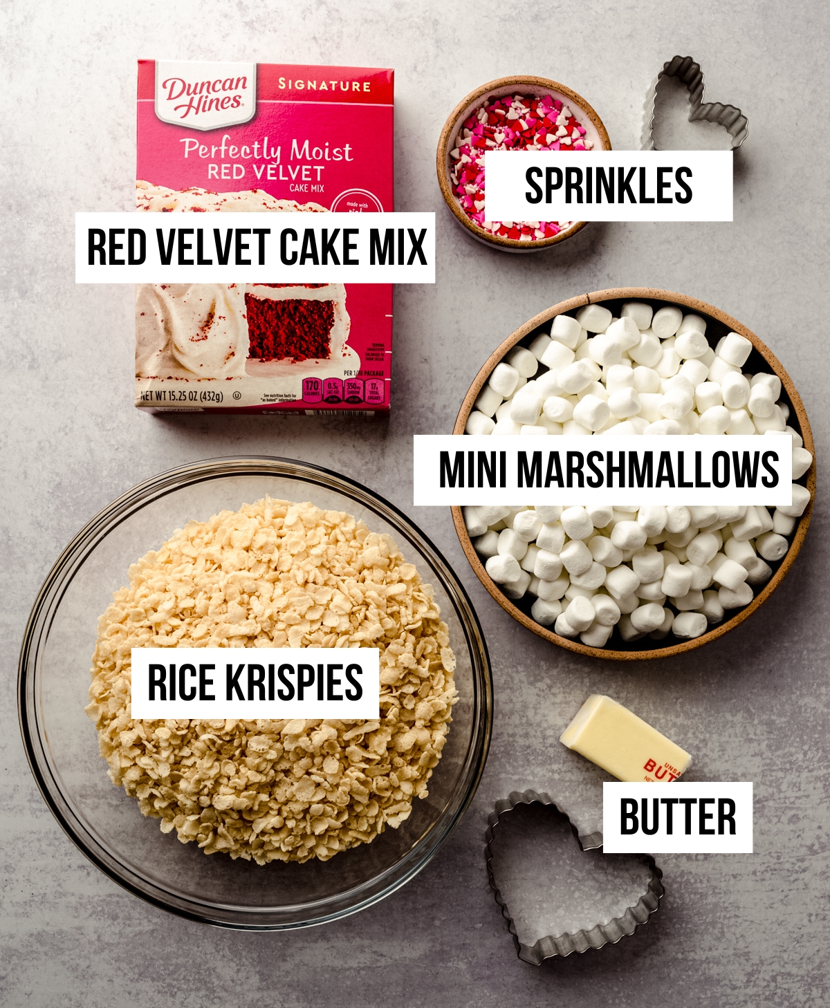 Aerial photo of ingredients for red velvet Rice Krispies treats with text overlay.