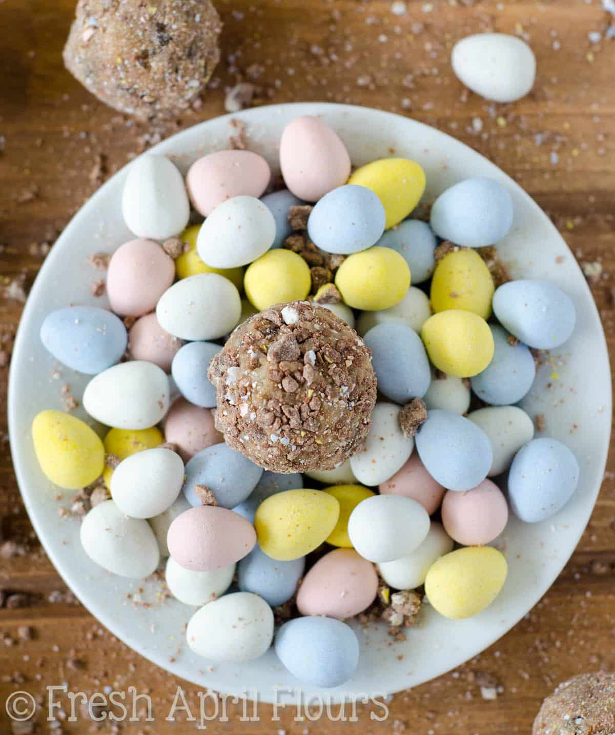 Cadbury Egg Cookie Dough Bites: Eggless and safe-to-eat chocolate chip cookie dough balls filled and coated with crunchy pieces of Cadbury Mini Eggs. The perfect treat for Easter!