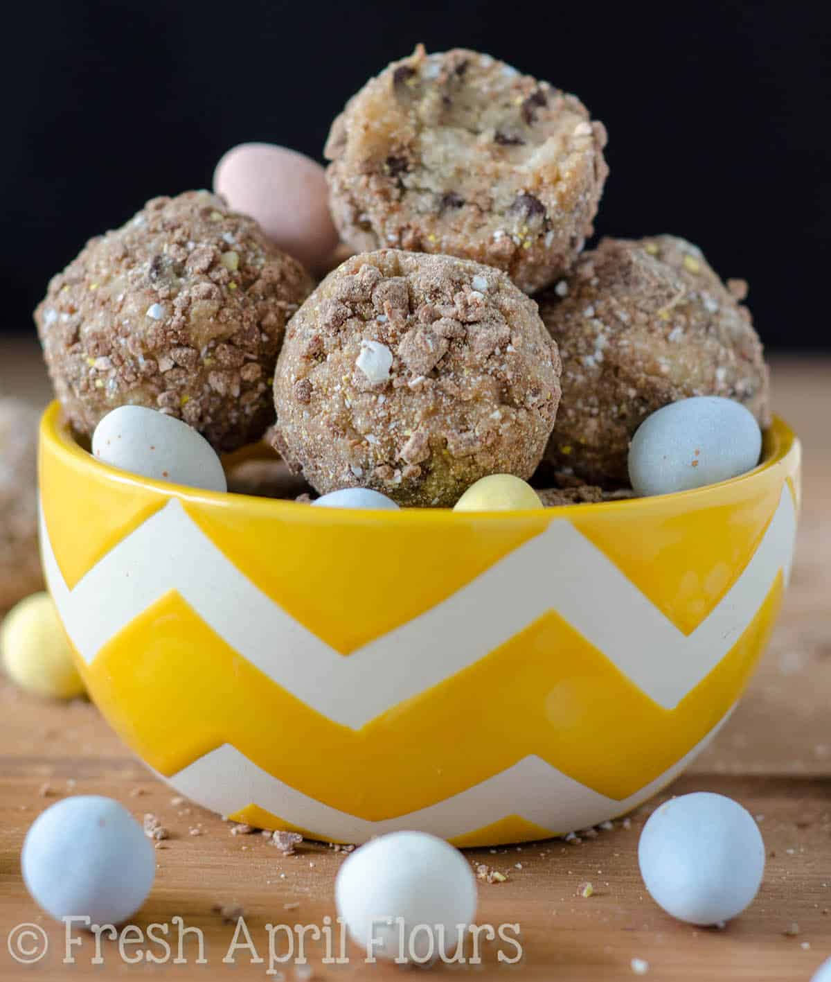 Chocolate Chip Mini Egg Cookie Dough Bites: Eggless and safe-to-eat chocolate chip cookie dough balls filled and coated with crunchy pieces of Cadbury Mini Eggs. The perfect treat for Easter!