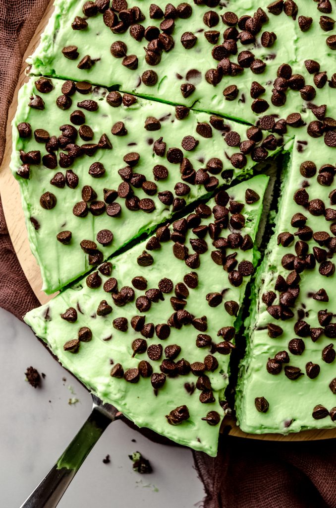 Aerial photo of a slice of mint chocolate chip pie being removed by a serving utensil.