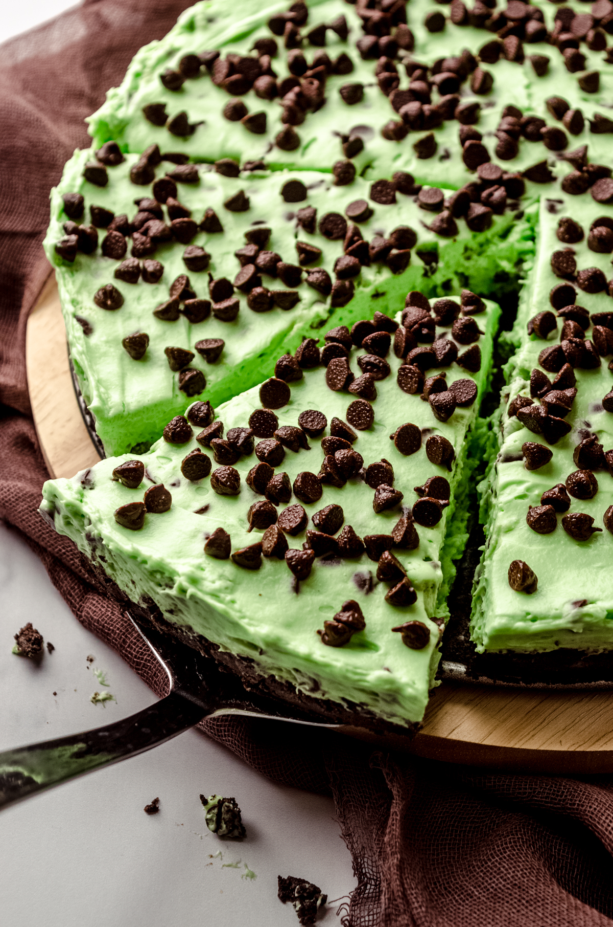 Photo of a slice of mint chocolate chip pie being removed by a serving utensil.