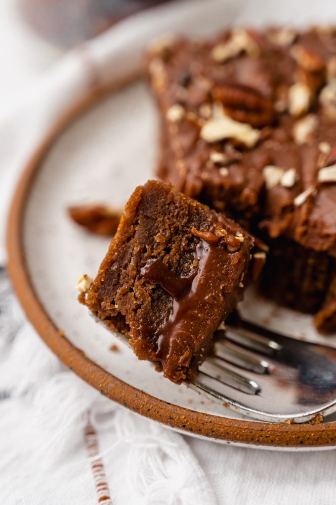 A closeup shot of a bite of chocolate Texas sheet cake on a fork.