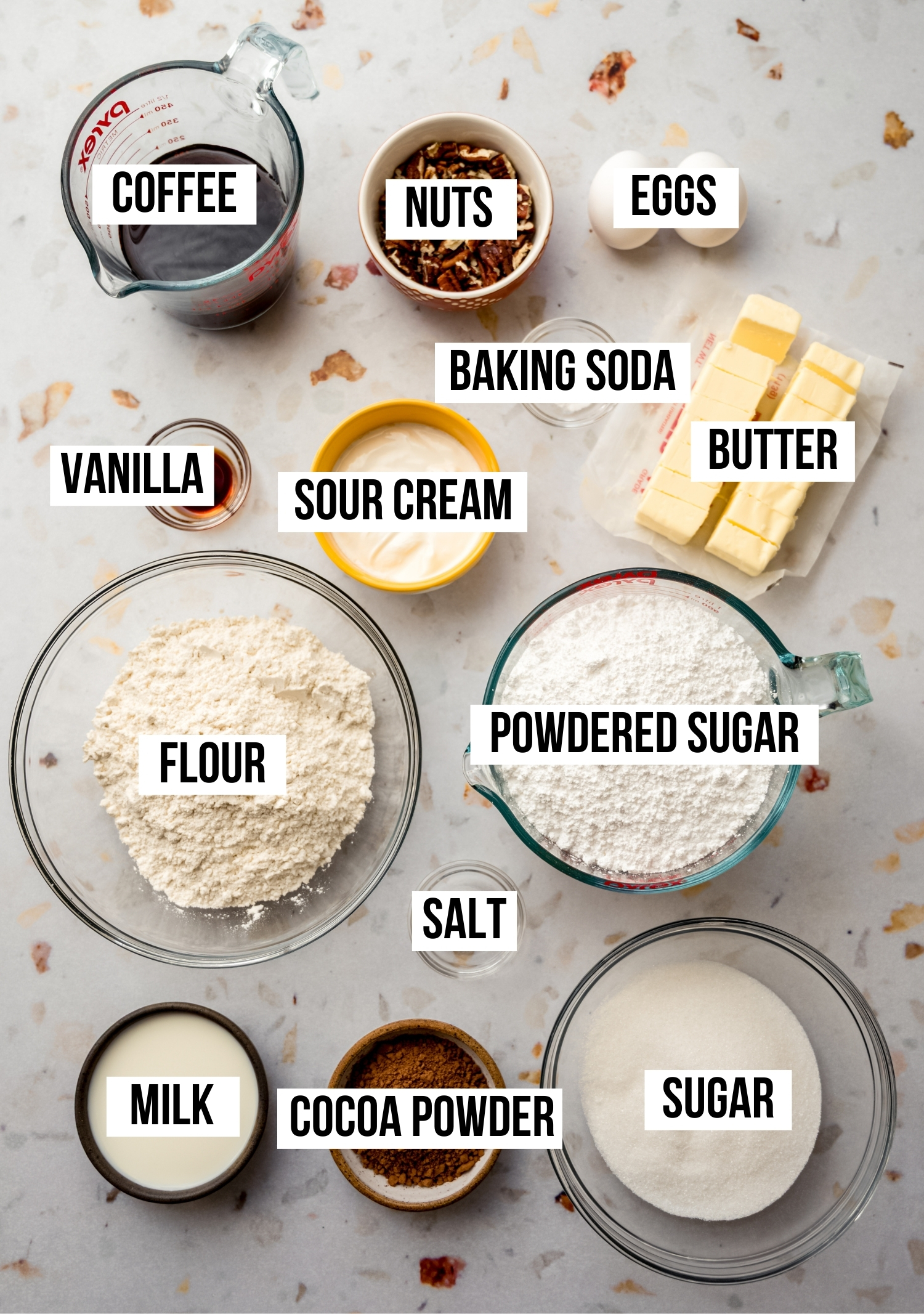 Aerial photo of ingredients to make Texas sheet cake with text overlay labeling each ingredient.