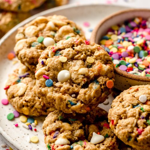 funfetti oatmeal cookies on a plate with a bowl of sprinkles