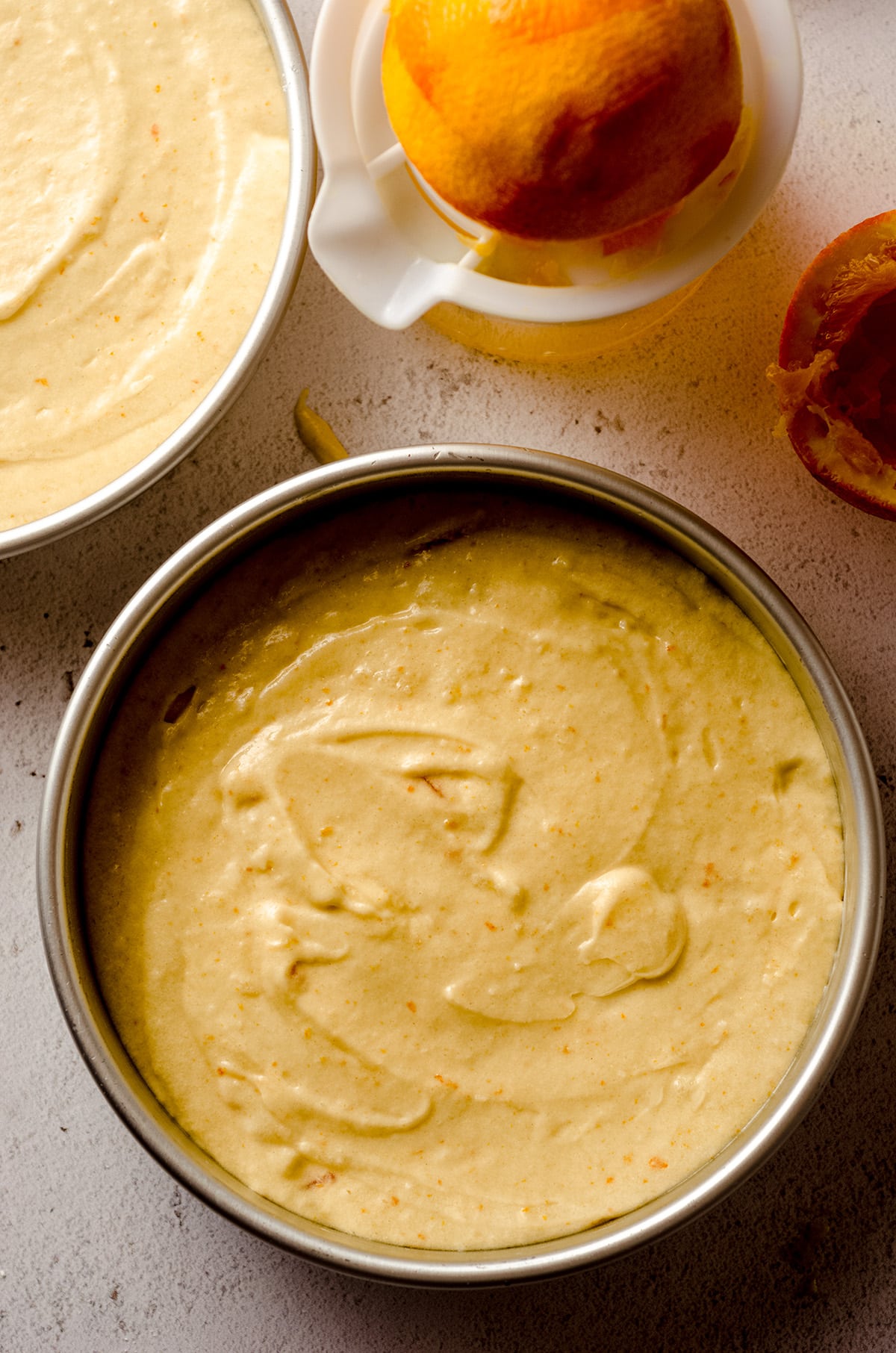 orange creamsicle layer cake batter in a baking pan