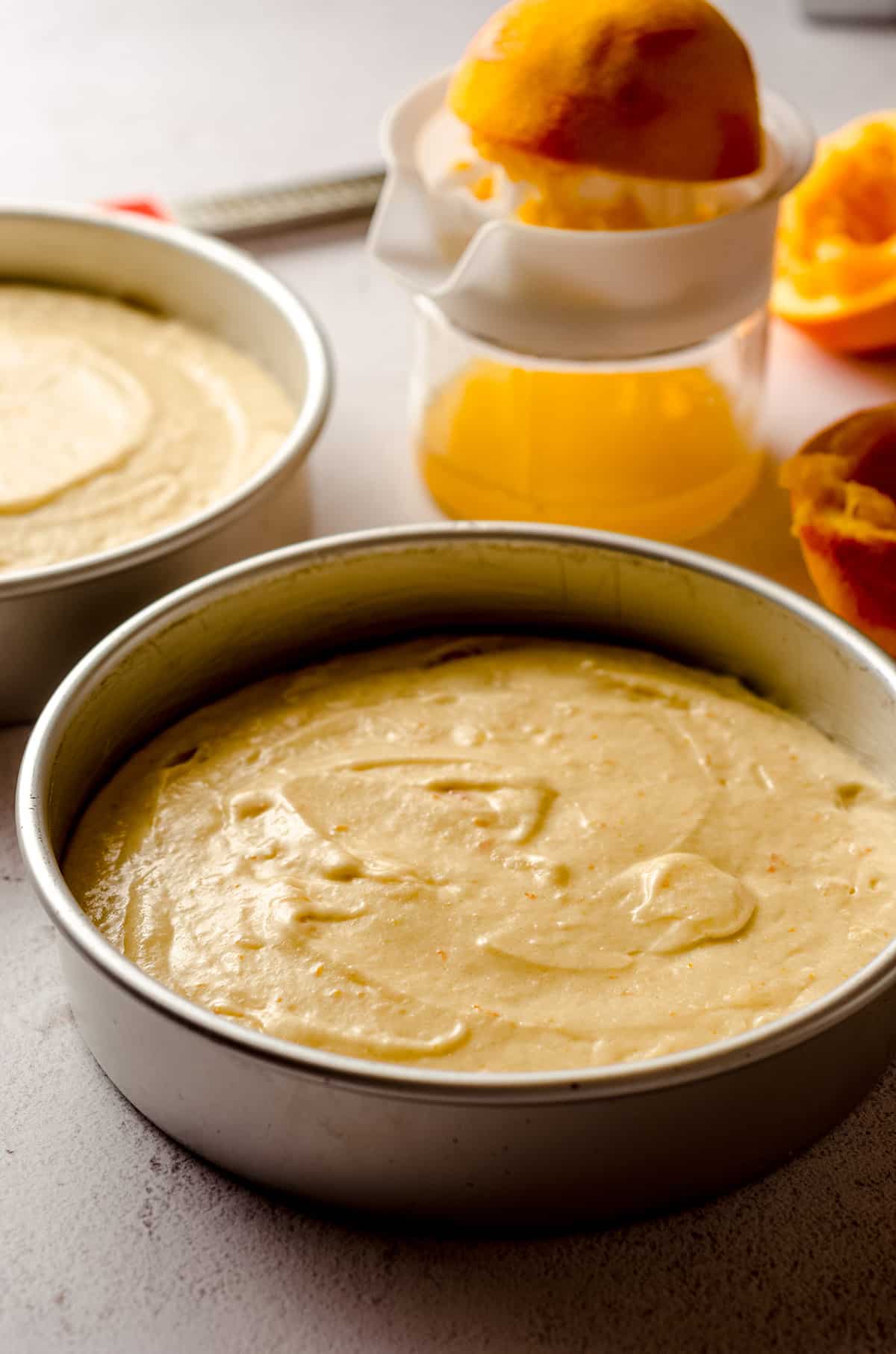 orange creamsicle layer cake batter in a baking pan