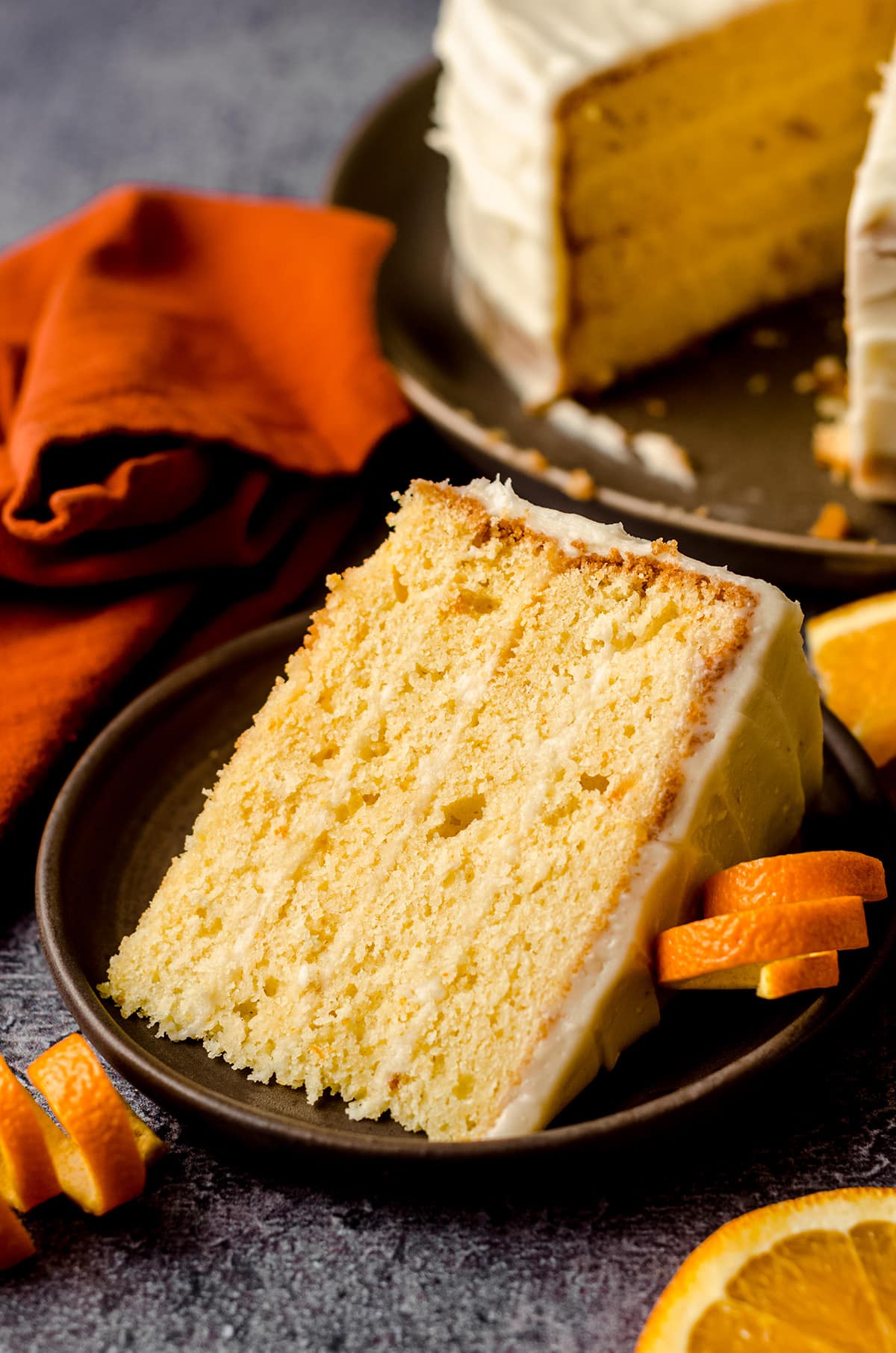 slice of orange creamsicle layer cake on a plate
