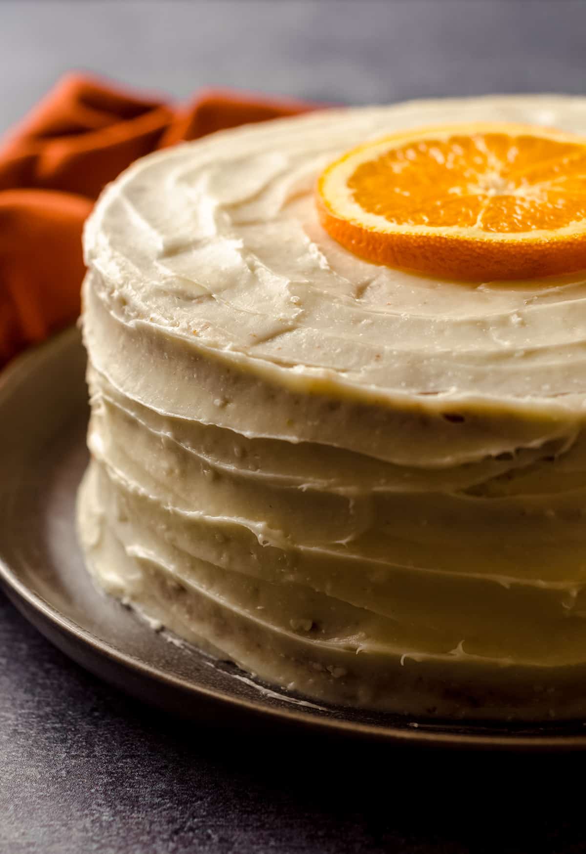 orange creamsicle layer cake on a plate