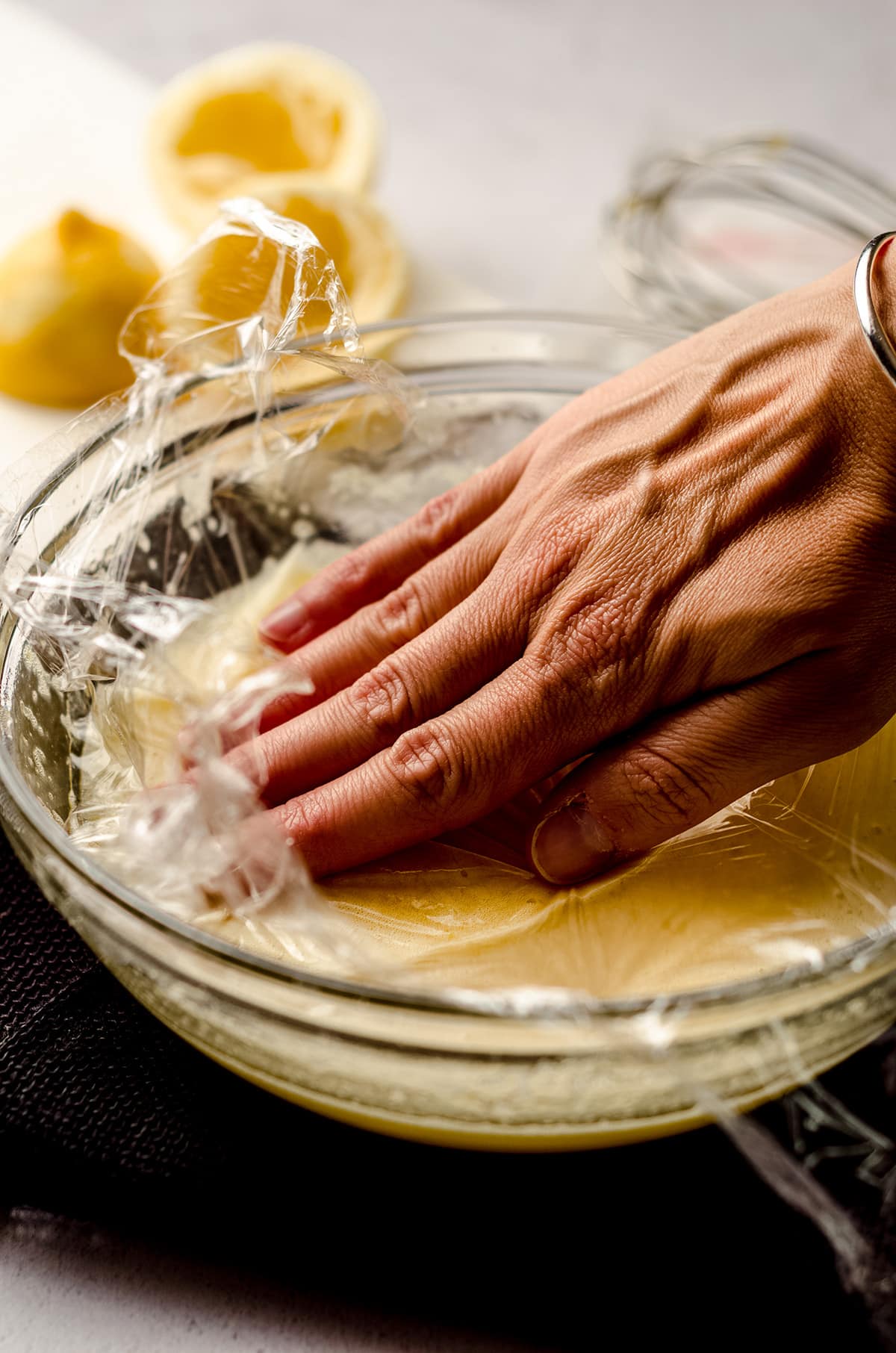 covering lemon curd with plastic wrap