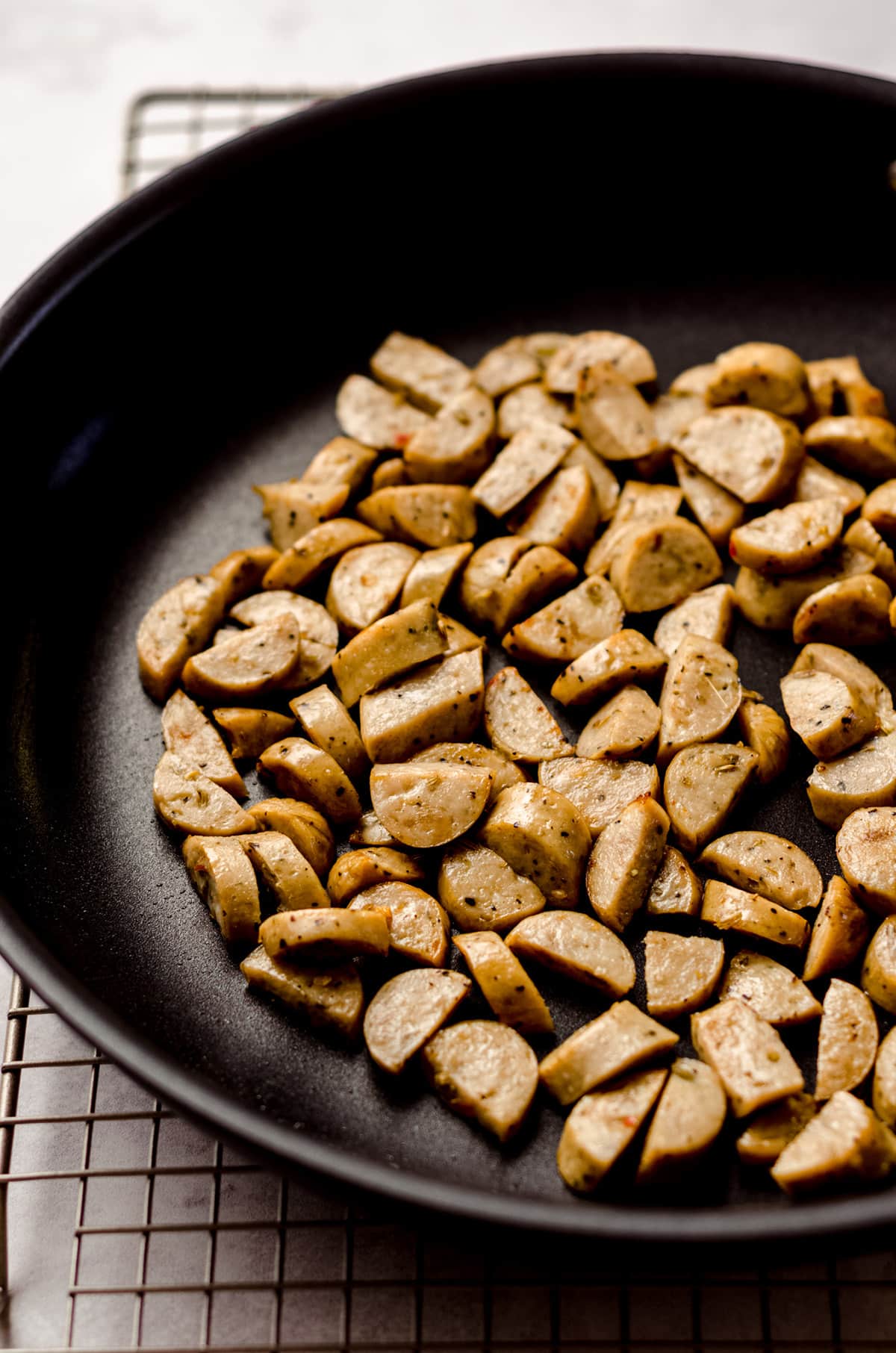 sliced, browned chicken sausage in a saucepan