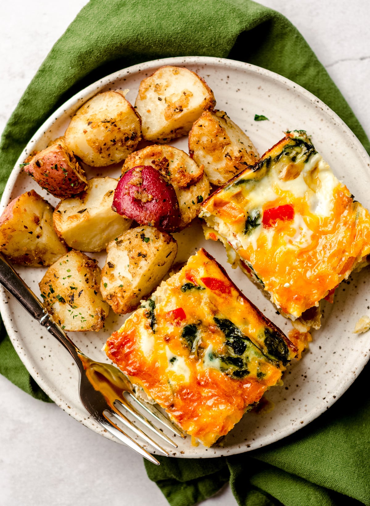 aerial photo of slices of breakfast casserole and breakfast potatoes on a plate