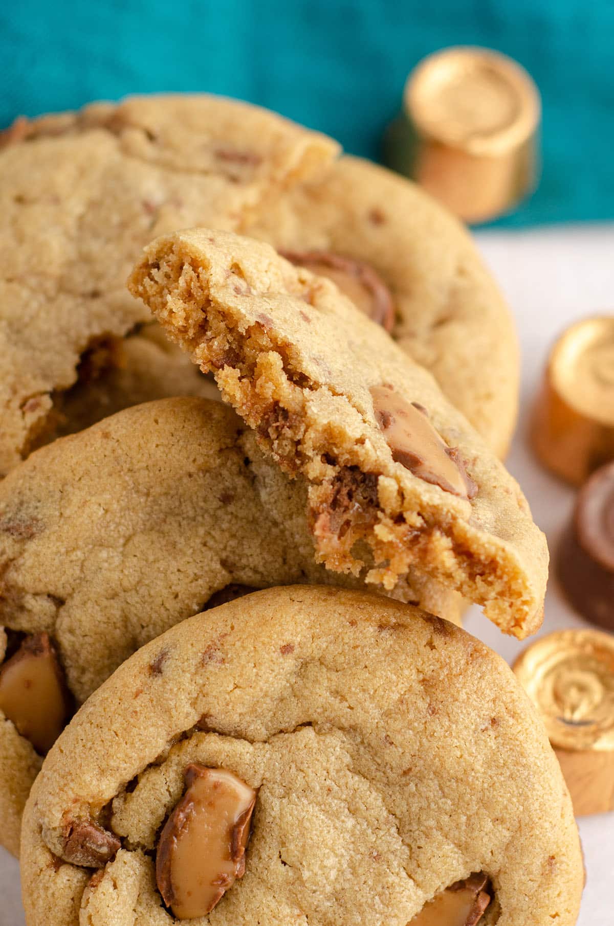 a peanut butter rolo cookie broken in half to see the inside of the cookie