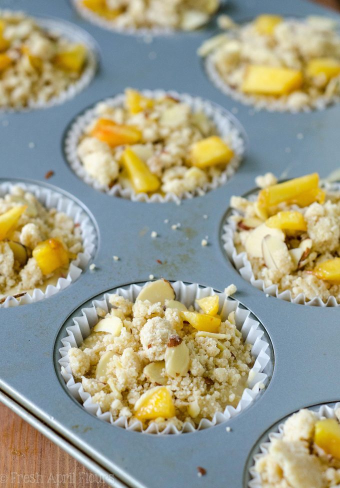 Peach Almond Streusel Muffins: Moist and tender peach muffins, accented with almond extract and topped with a sweet and crunchy almond streusel.