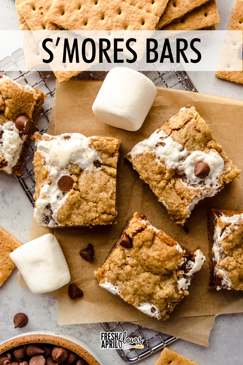 Two layers of graham cookie bars filled with a thick and gooey layer of marshmallow creme and creamy milk chocolate chips. They're soft, chewy, and full of all the gooeyness you love from traditional s'mores.  via @frshaprilflours