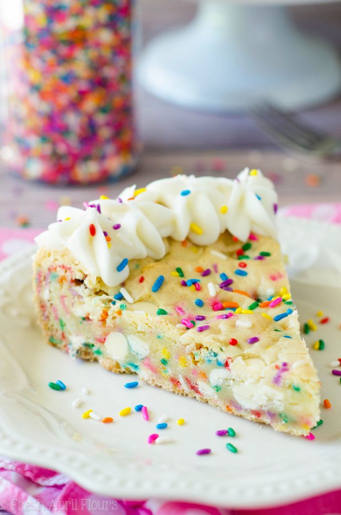 Funfetti Sugar Cookie Cake: Soft and buttery in the center, crunchy around the edges, and filled with plenty of white chocolate chips and sprinkles to celebrate any occasion. Topped with a creamy and buttery almond vanilla buttercream.