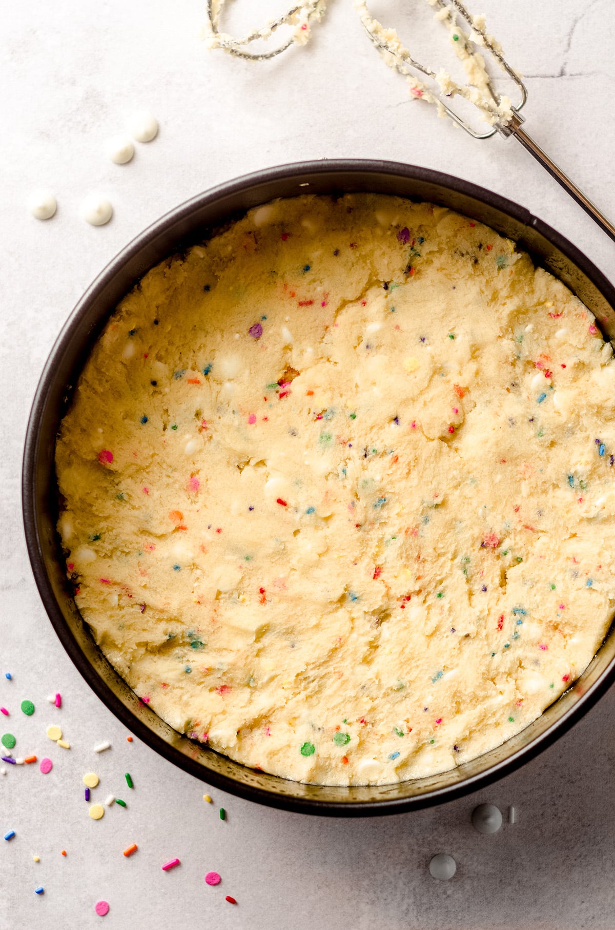 aerial photo of funfetti sugar cookie dough in a springform pan