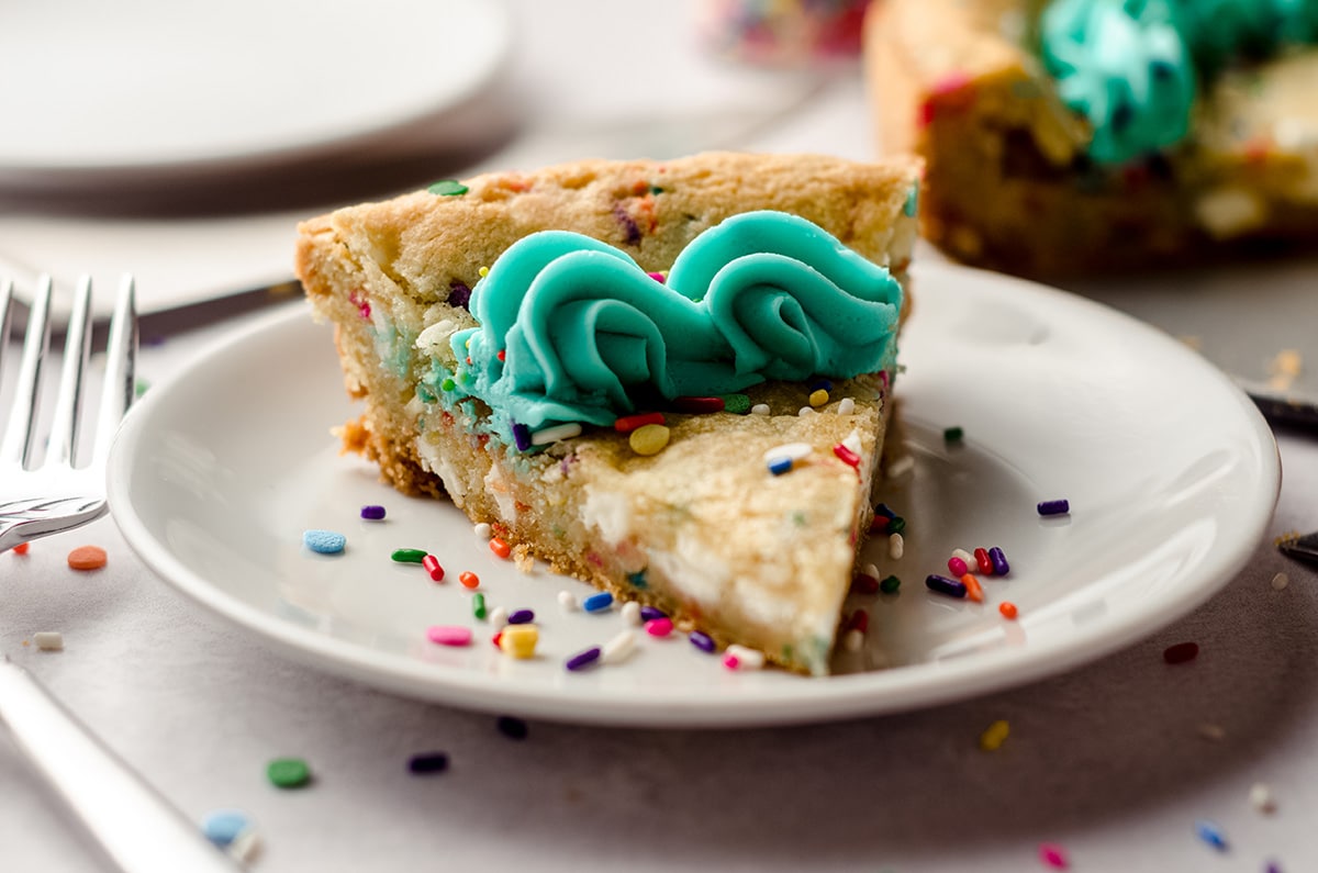 a slice of funfetti sugar cookie cake on a plate