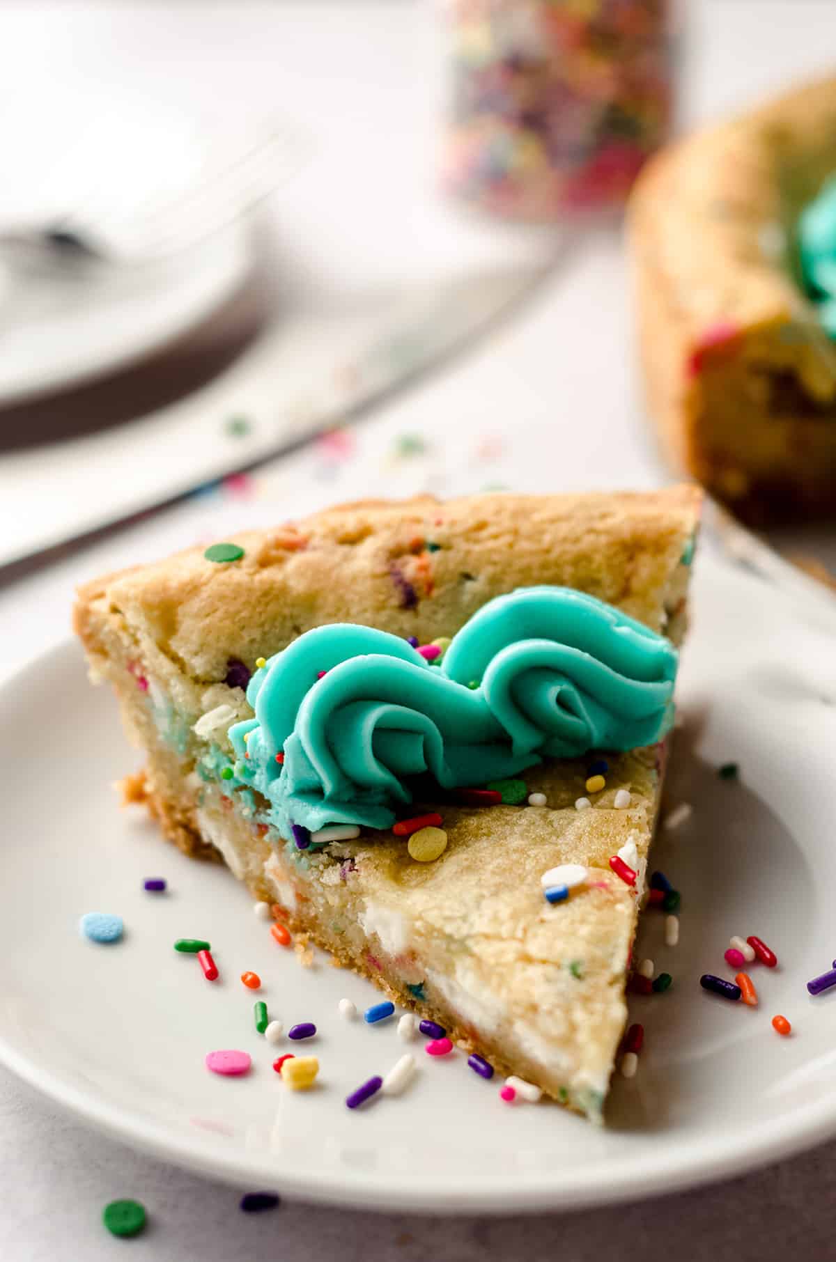 a slice of funfetti sugar cookie cake on a plate
