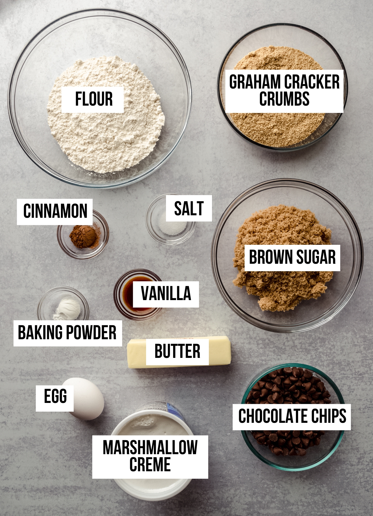 Aerial photo of ingredients to make s'mores bars with text overlay labeling each ingredient.