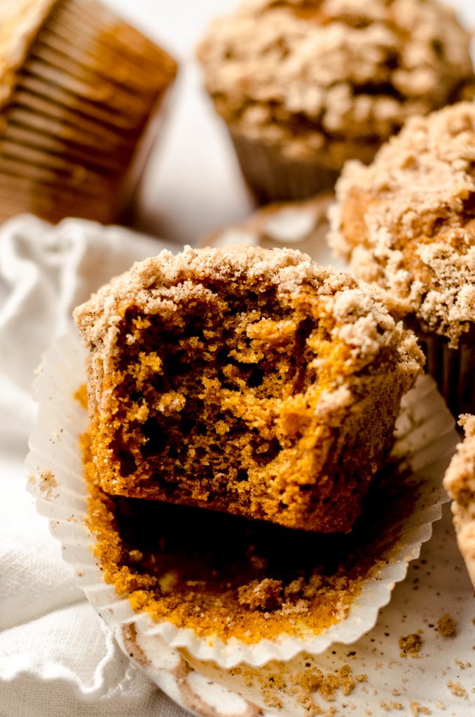 pumpkin streusel muffin with a bite taken out of it